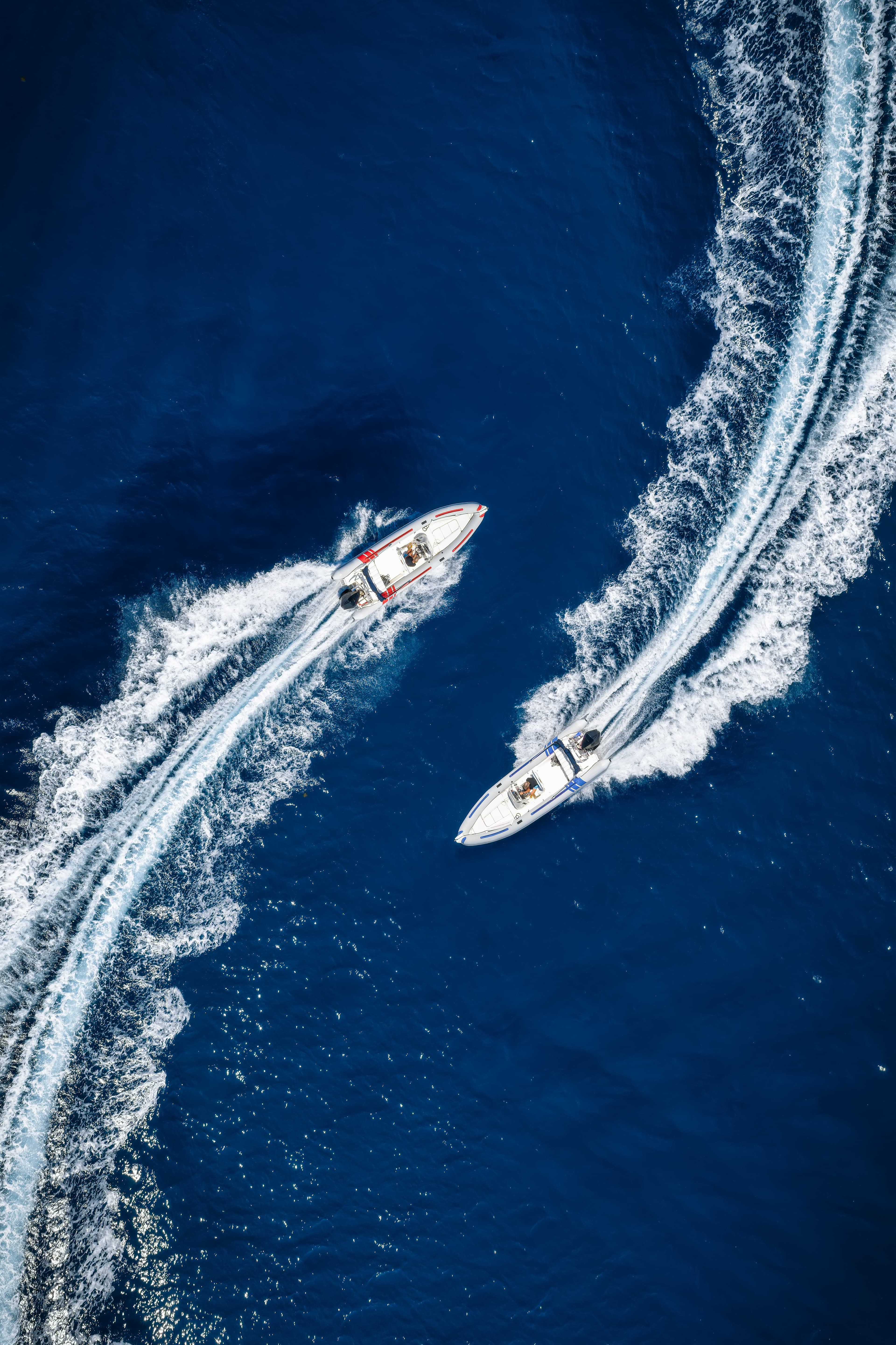 Two boats crossing wakes, shot from above